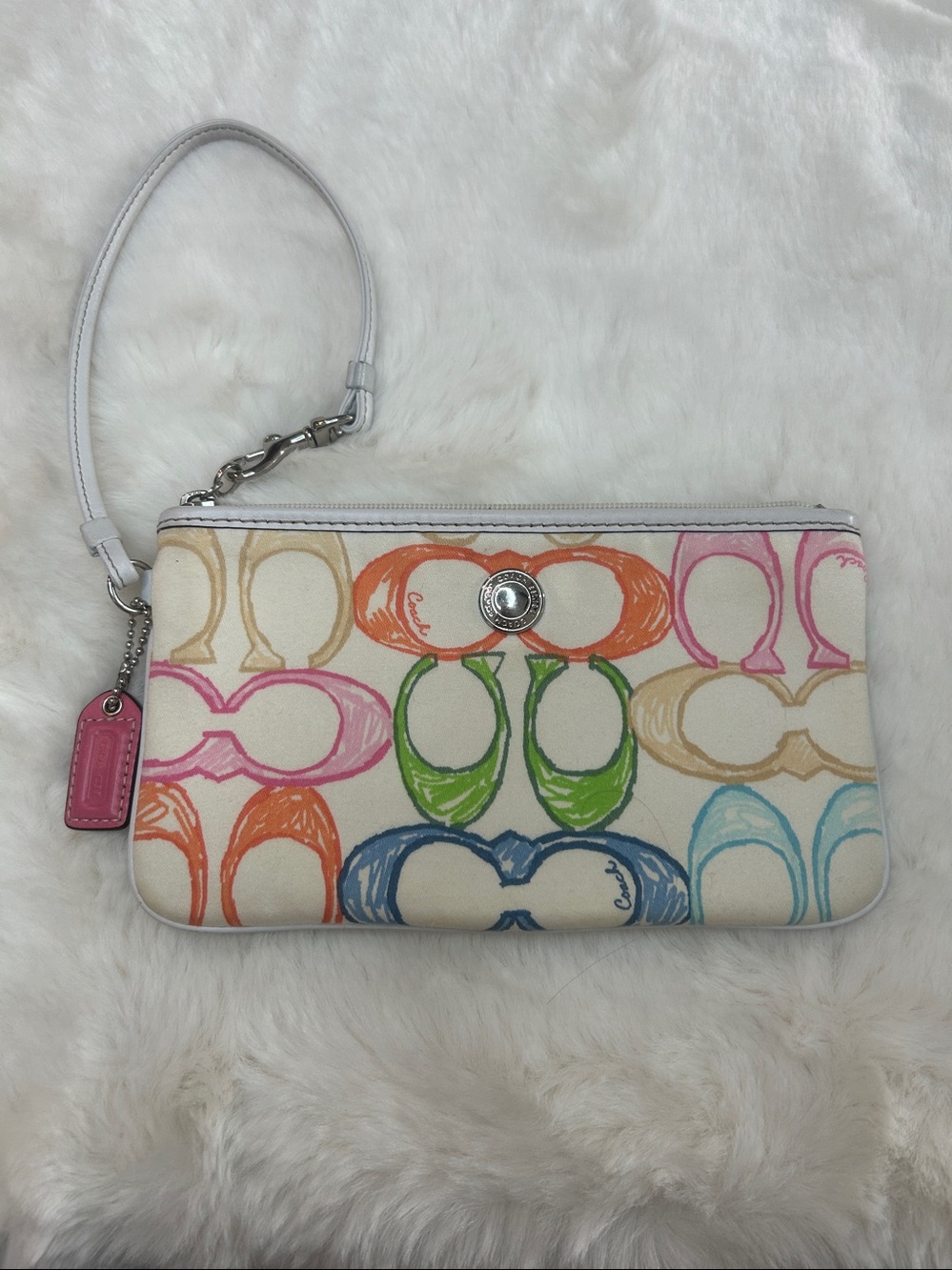 Coach Multicolor Signature Wristlet with White Background and pink hang tag